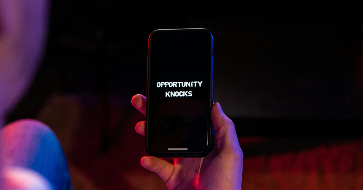 Phone screen that reads: opportunity knocks, to represent opportunities in AI for those with first-mover advantage. 
