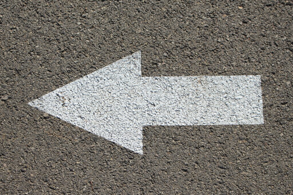 An arrow painted on the pavement indicating which way to go. 