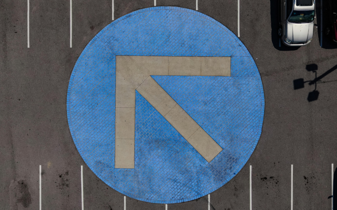 arrow painted on an intersection, pointing at an angle to suggest the current funding climate may or may not turn around.